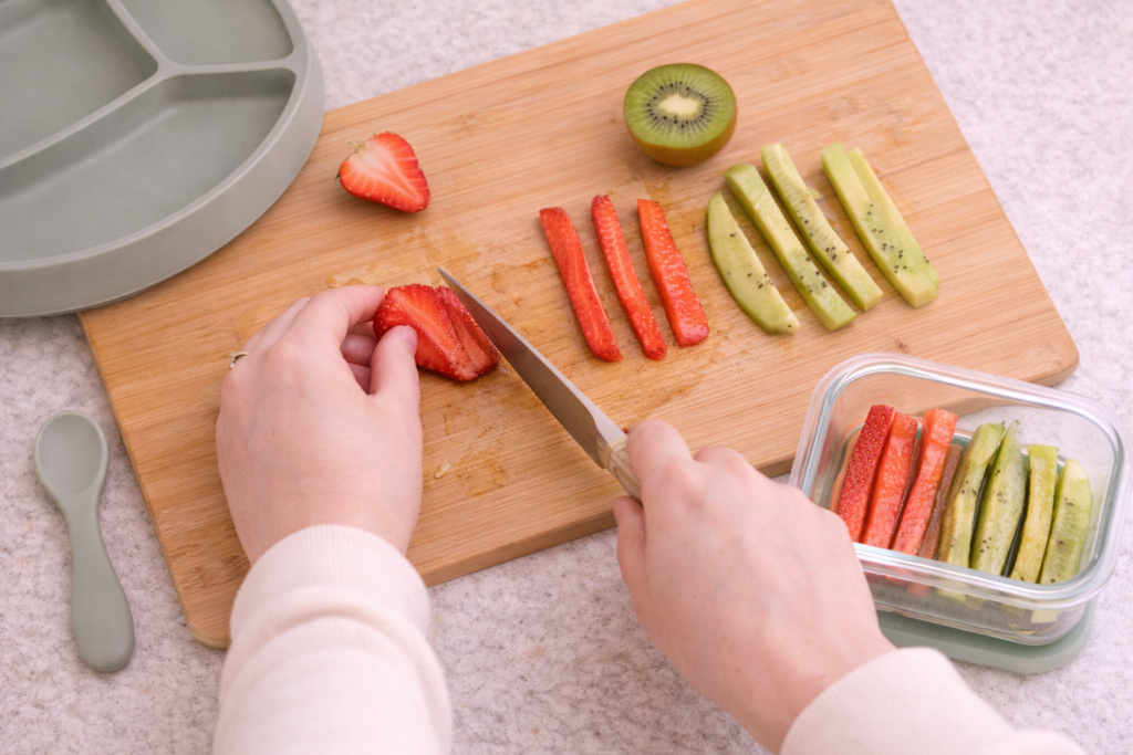 Kitchen counter with baby meal prep containers filled with soft finger foods