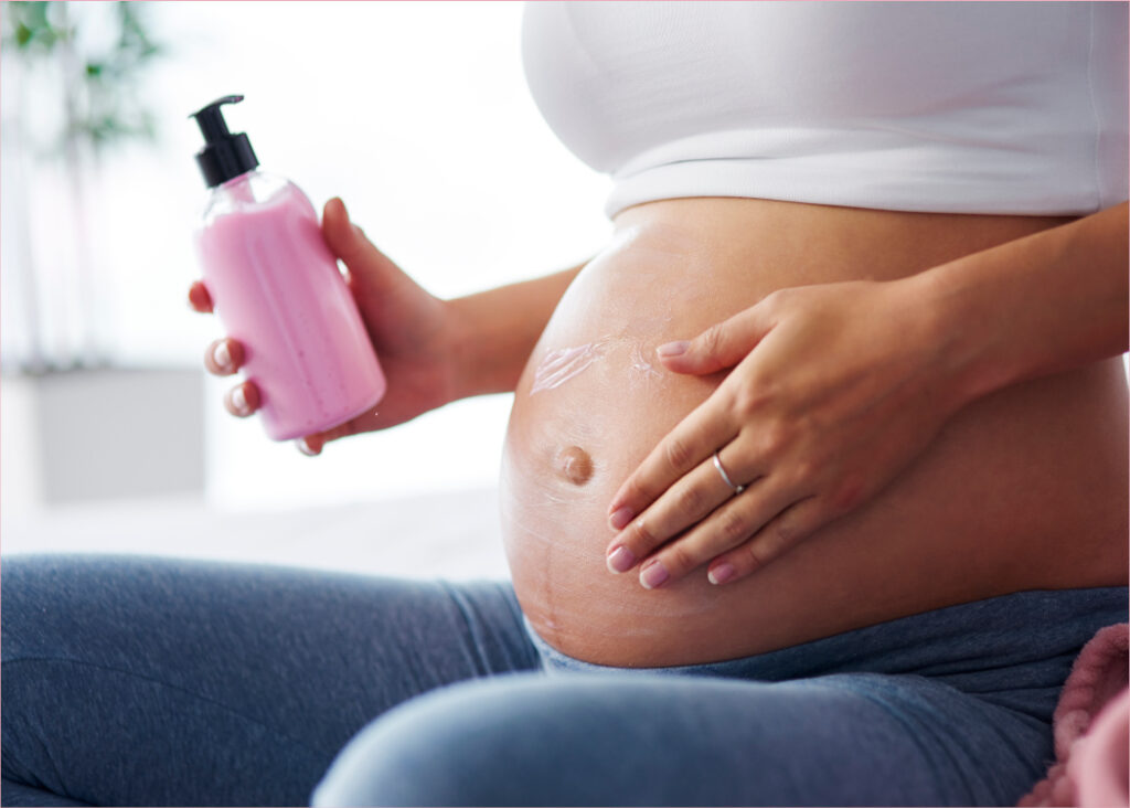 Pregnant women applying cream